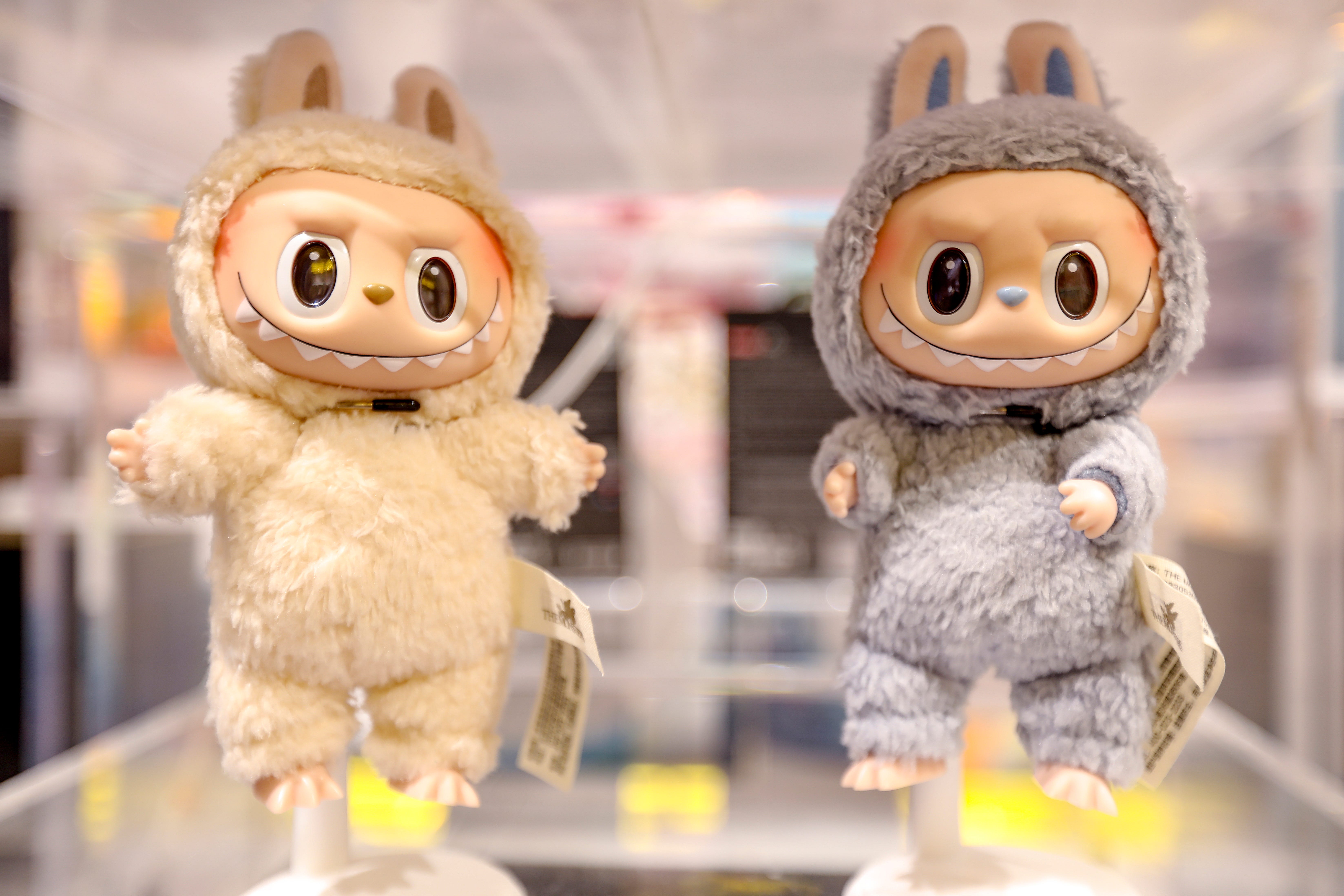 an oatmeal and gray labubu on display