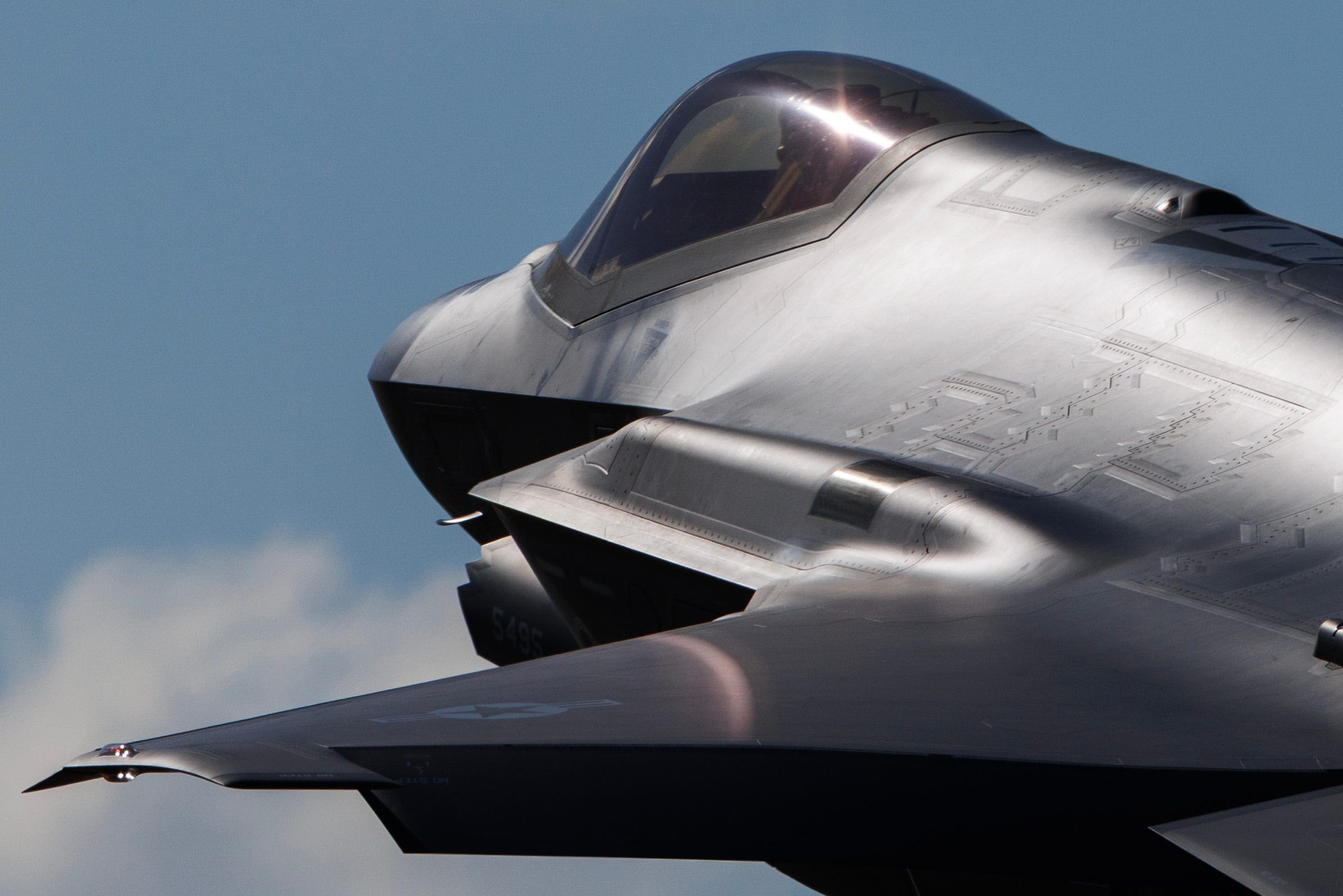 A close-up of the back of an F-35A cockpit as the stealth fighter comes in to land.