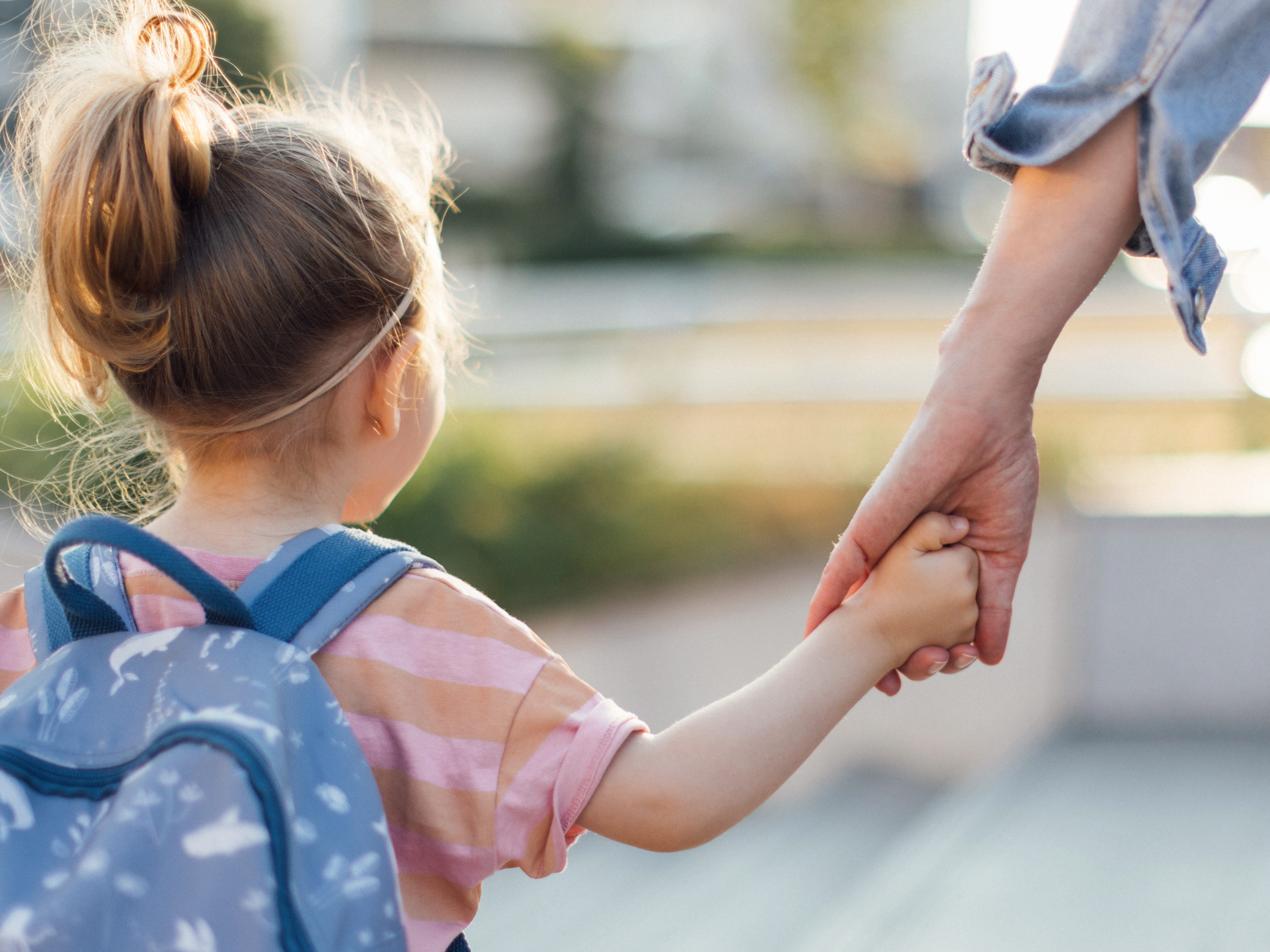 Unrecognizable Daughter Being Taken To School By Her Mother