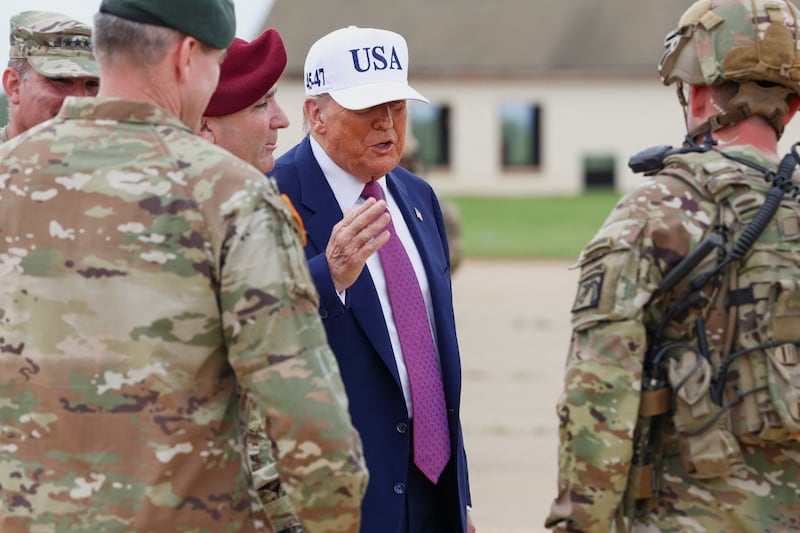U.S. President Donald Trump speaks with Army members during a visit to Fort Bragg on Tuesday.