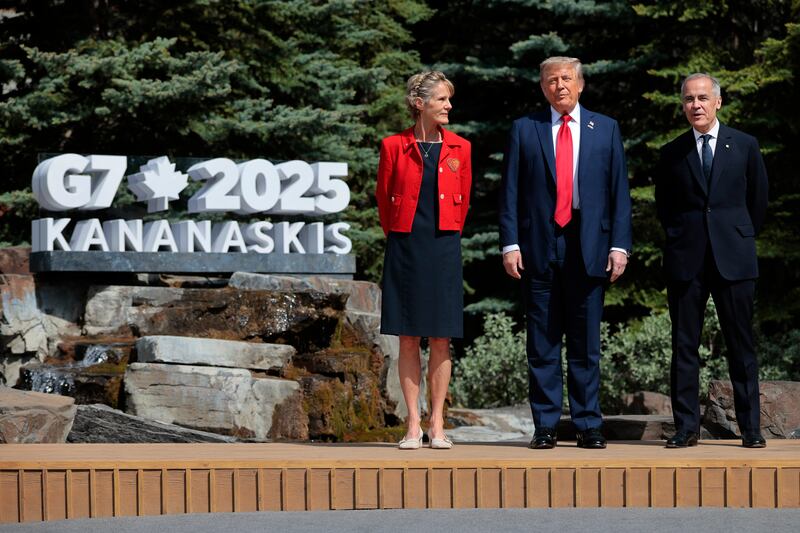 President Donald Trump poses for a photo with Canadian Prime Minister Mark Carney and his wife Diana Fox Carney at the official welcome ceremony during the G7 Leaders' Summit on June 16, 2025 in Kananaskis, Alberta, Canada.