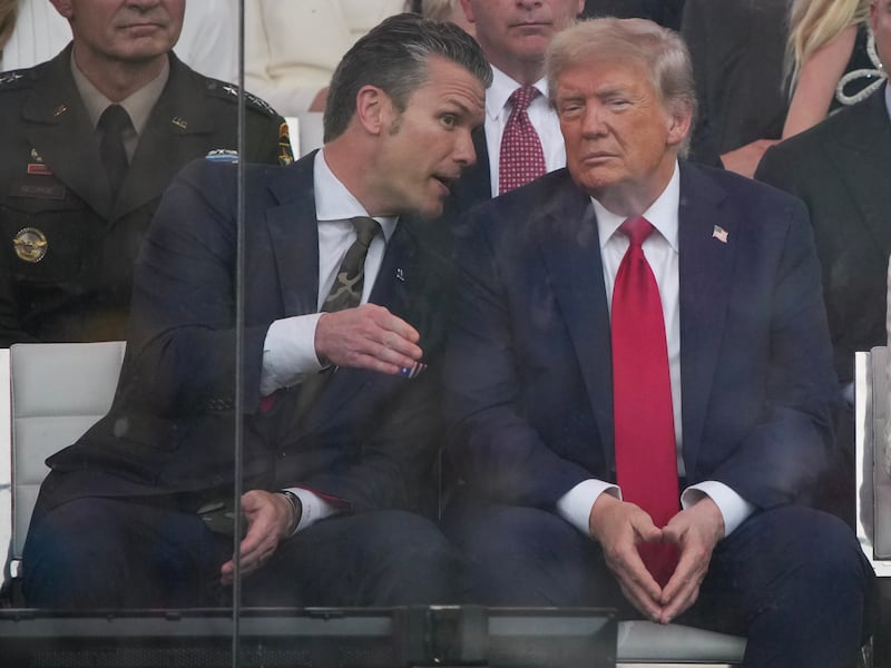 President Donald Trump watches the military parade along with Secretary of Defense Pete Hegseth (L) and wife Melania Trump on June 14, 2025 in Washington, DC.