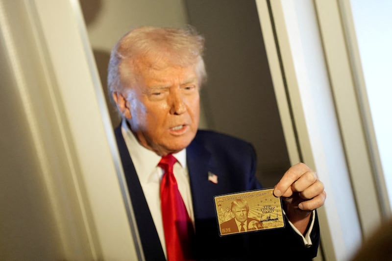 U.S. President Donald Trump holds "The Trump Card" on Air Force One.