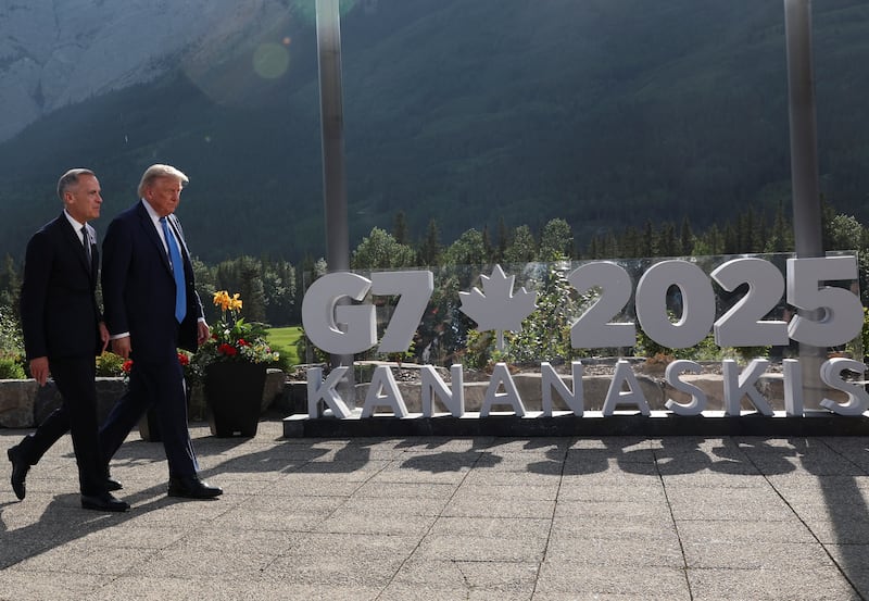Canada's Prime Minister Mark Carney and U.S. President Donald Trump leave after a family photo session during the G7 Summit.