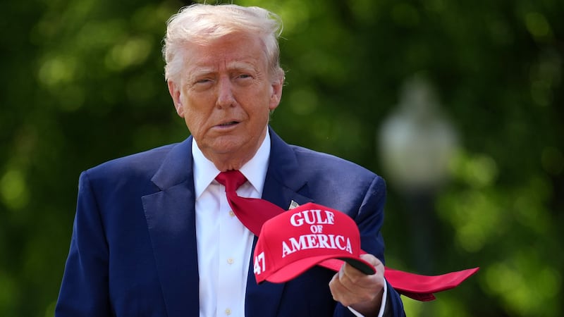 WASHINGTON, DC - APRIL 29: U.S. President Donald Trump holds a hat as he walks to speak to members of the media before boarding Marine One on the South Lawn of the White House on April 29, 2025 in Washington, DC. Trump will travel to Michigan for a 100th Day in Office rally. (Photo by Andrew Harnik/Getty Images)