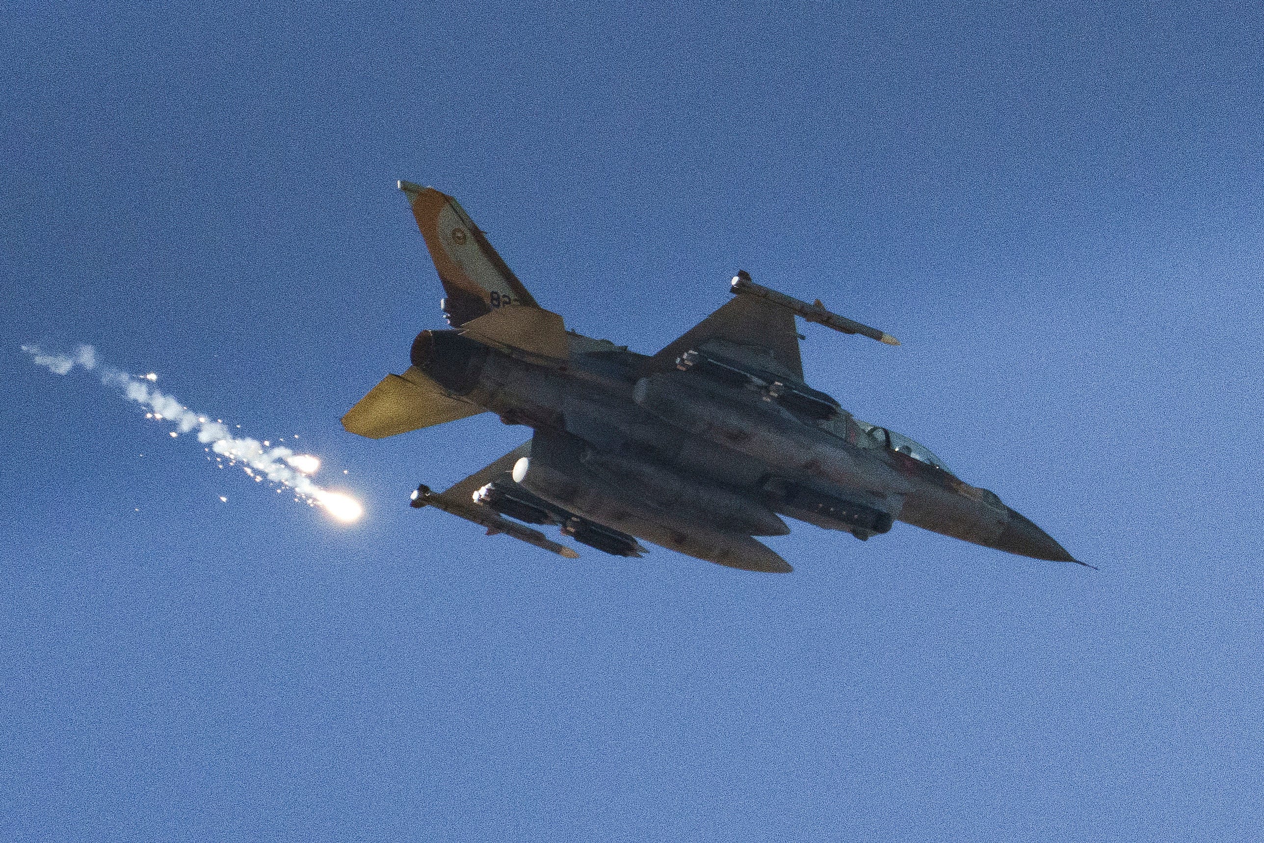 FILE - An Israeli fighter jet releases flares as it flies over the Gaza Strip, as seen from southern Israel, Dec. 9, 2023.