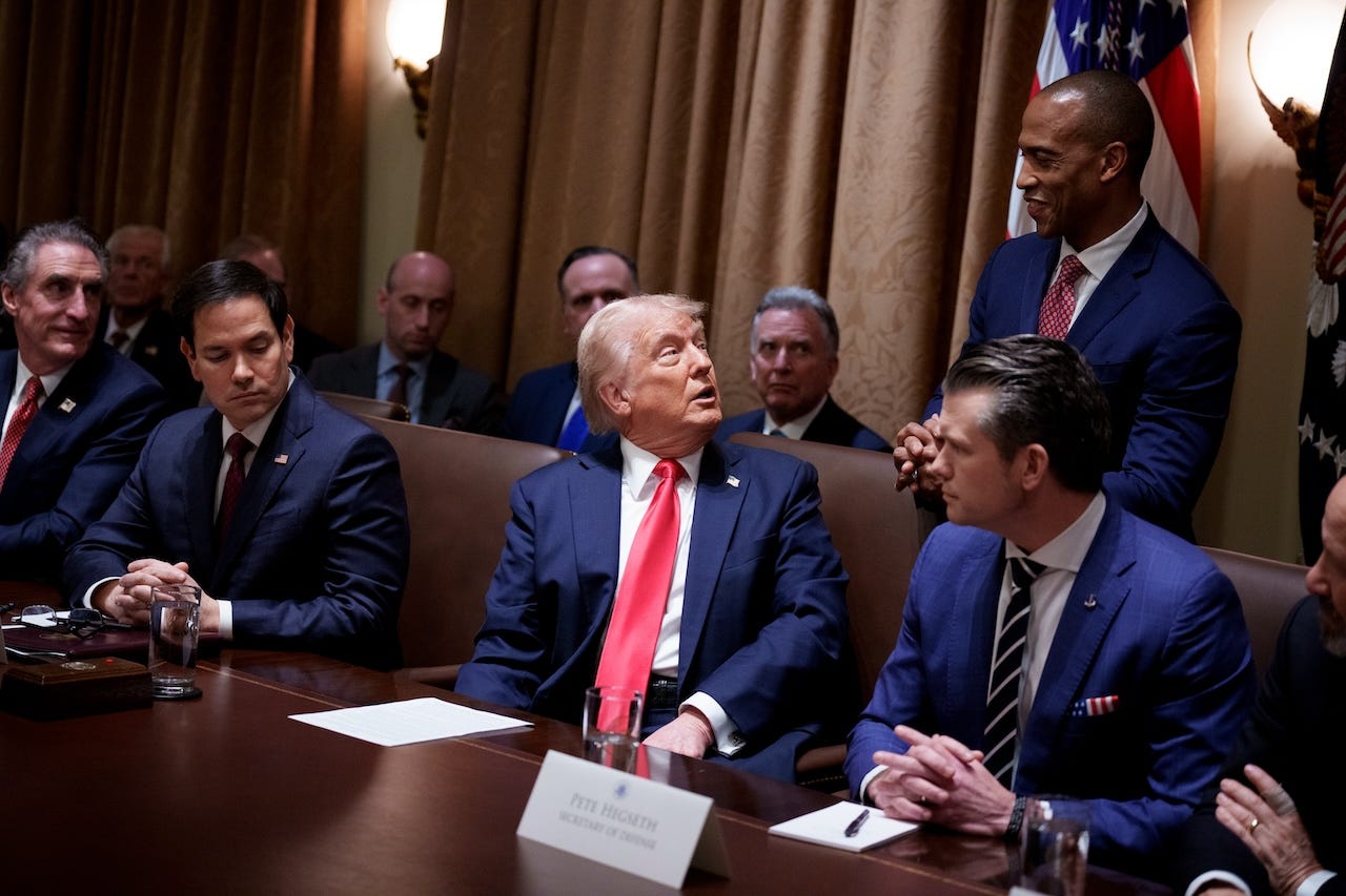 Secretary of Housing and Urban Development Scott Turner stands next to President Donald Trump during a cabinet meeting.
