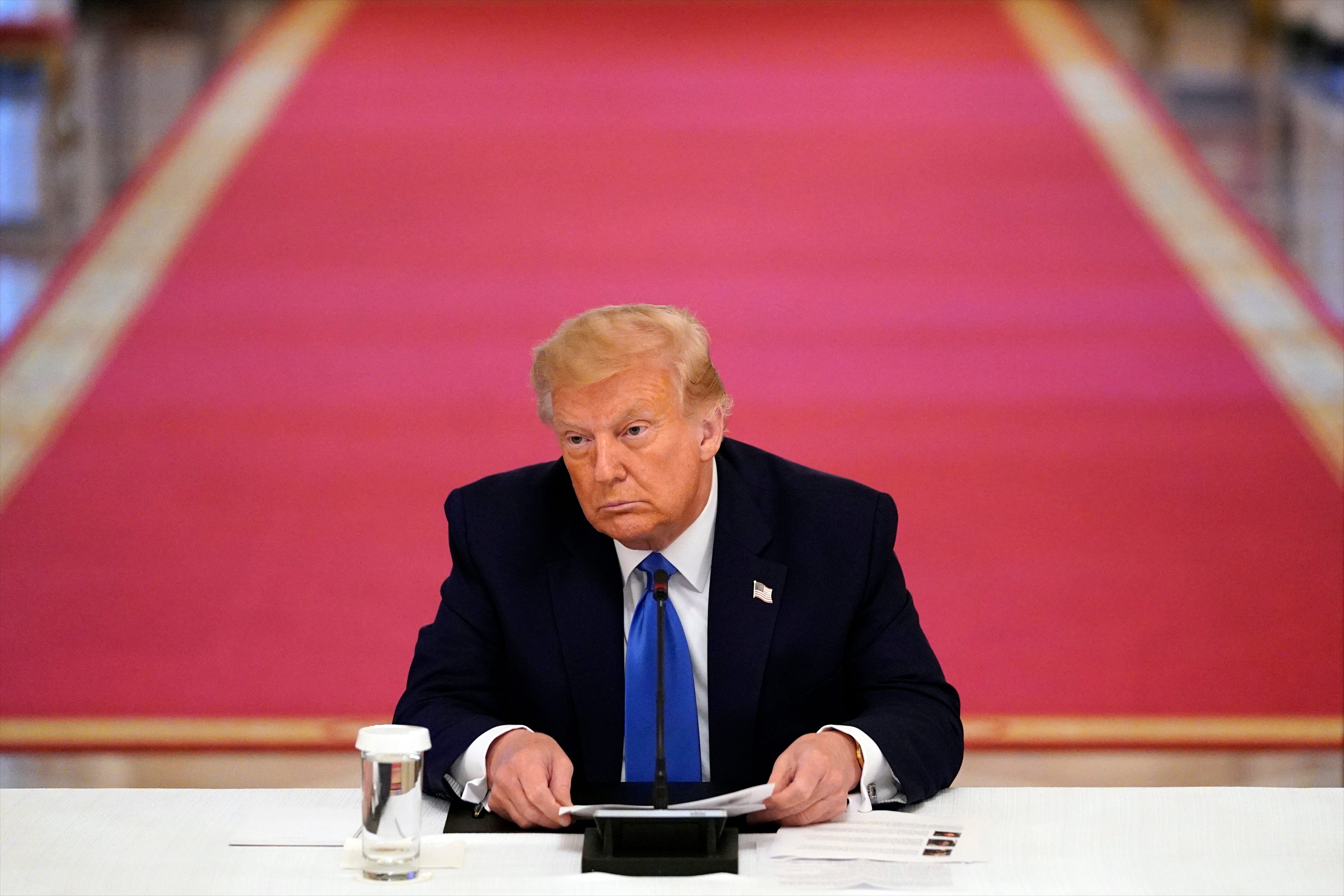 President Donald Trump listens during roundtable with people positively impacted by law enforcement, Monday, July 13, 2020, in Washington. (AP Photo/Evan Vucci)