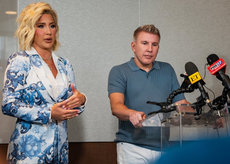 Todd Chrisley and daughter Savannah speak at a press conference celebrating Trump's pardon.