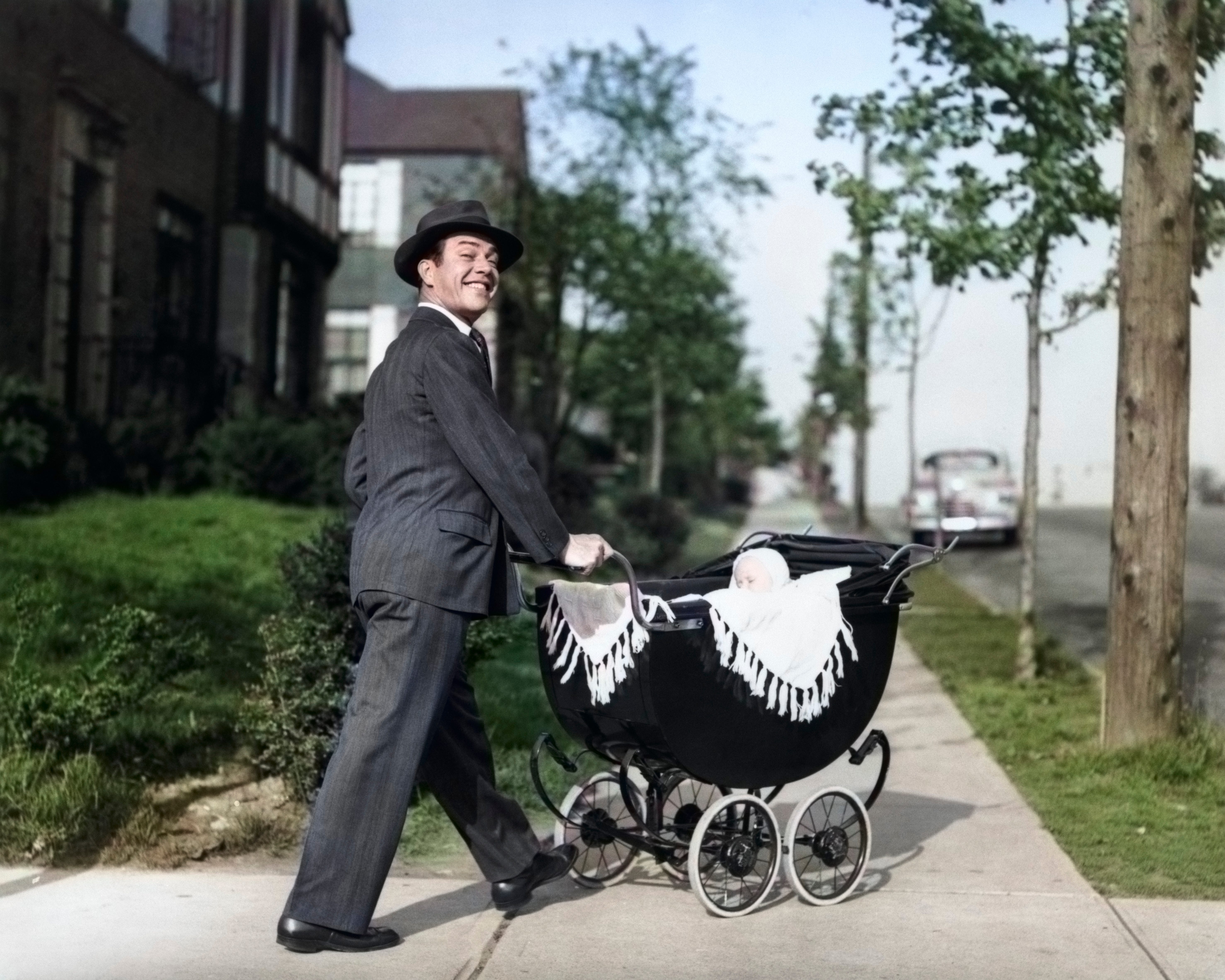father walking baby in a stroller