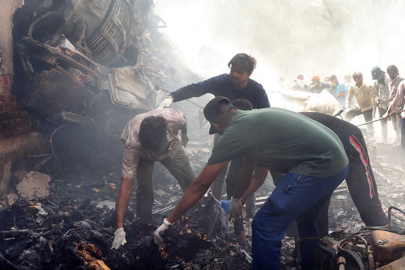Rescue officials work at the site where Air India flight 171 crashed in a residential area near the airport in Ahmedabad on June 12, 2025.