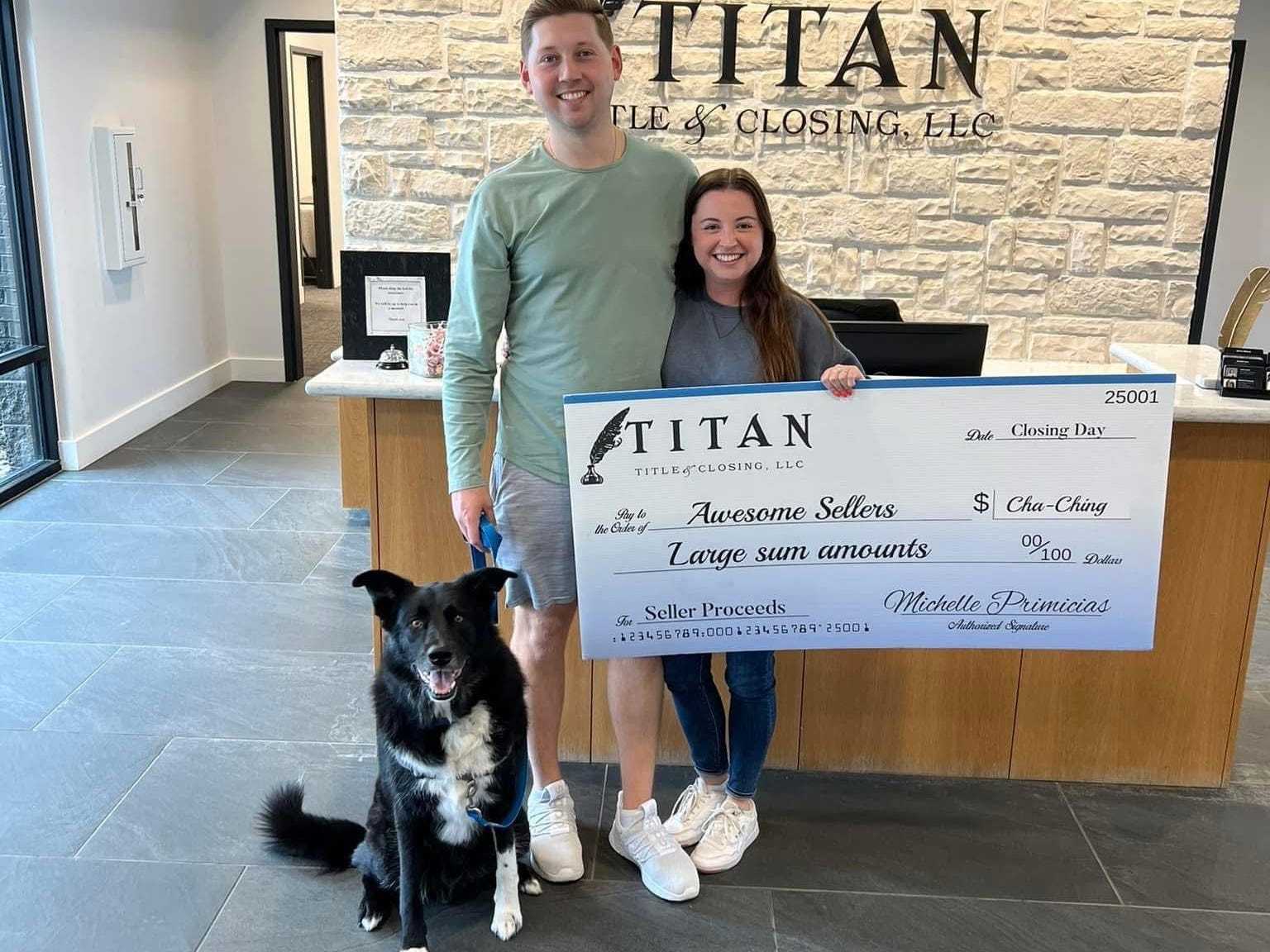 Abigale Albera with her husband holding a check for closing on their home