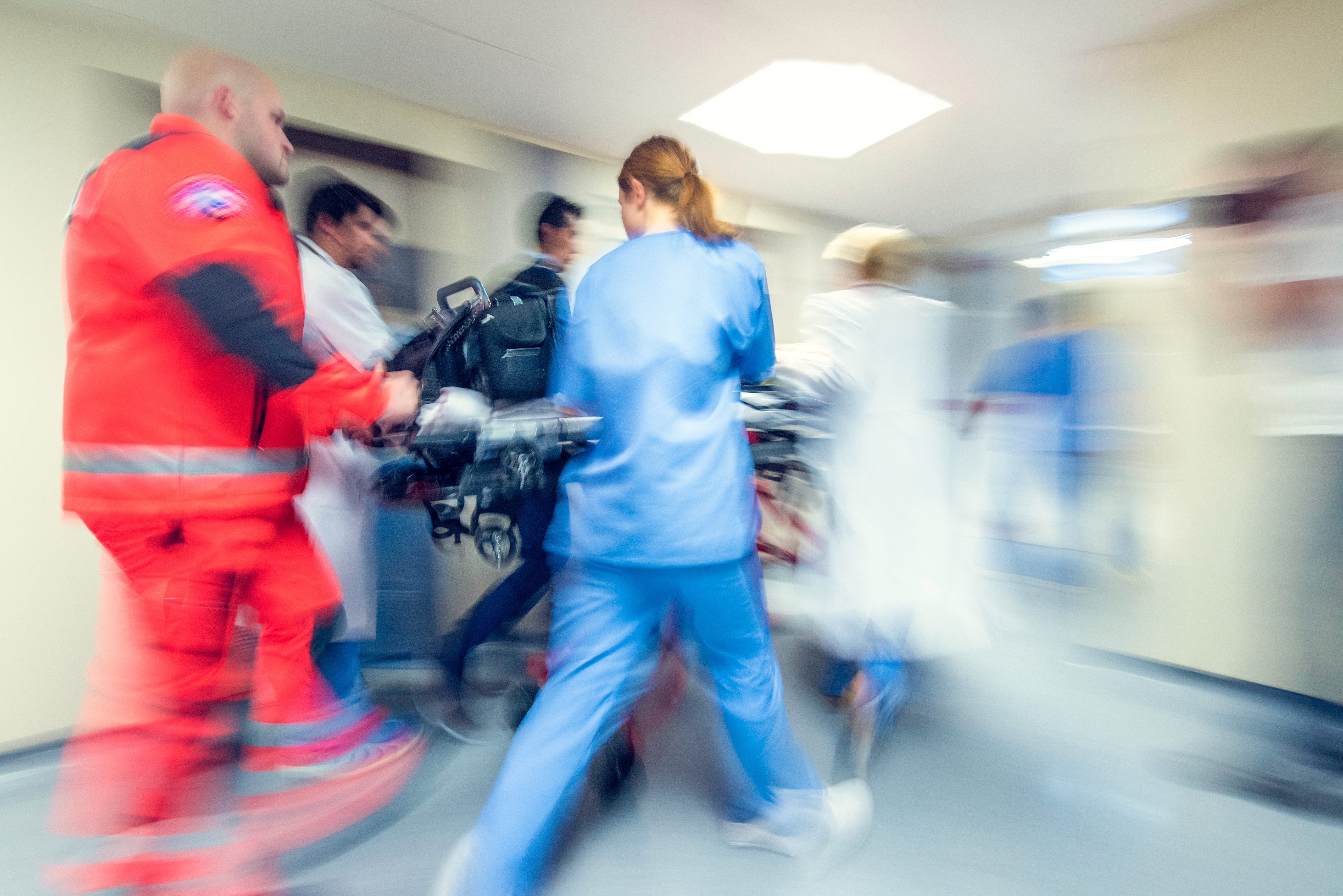 Someone being rushed into an emergency room on a stretcher