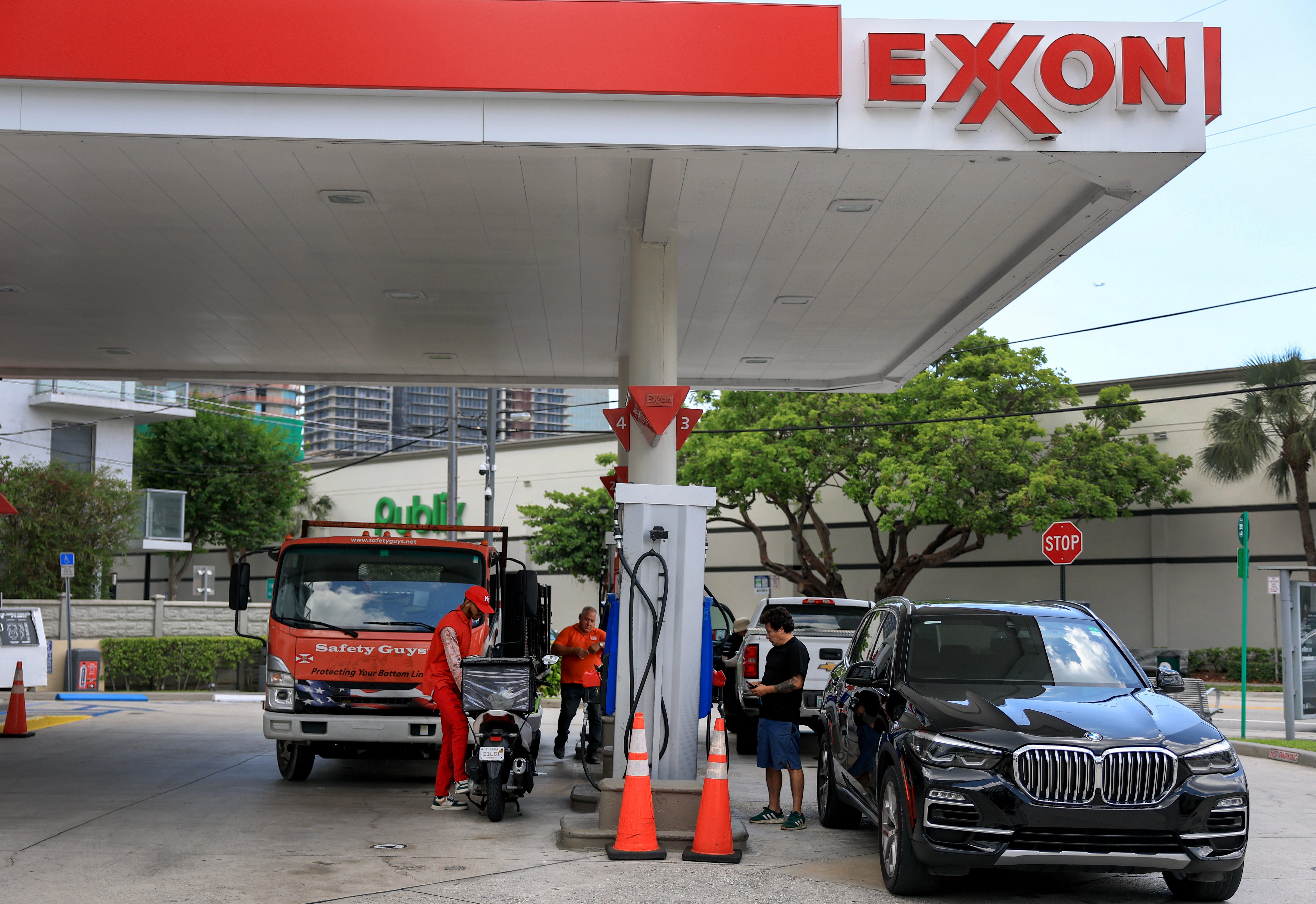 Customers fill their cars at an Exxon gas station in Miami, Florida.