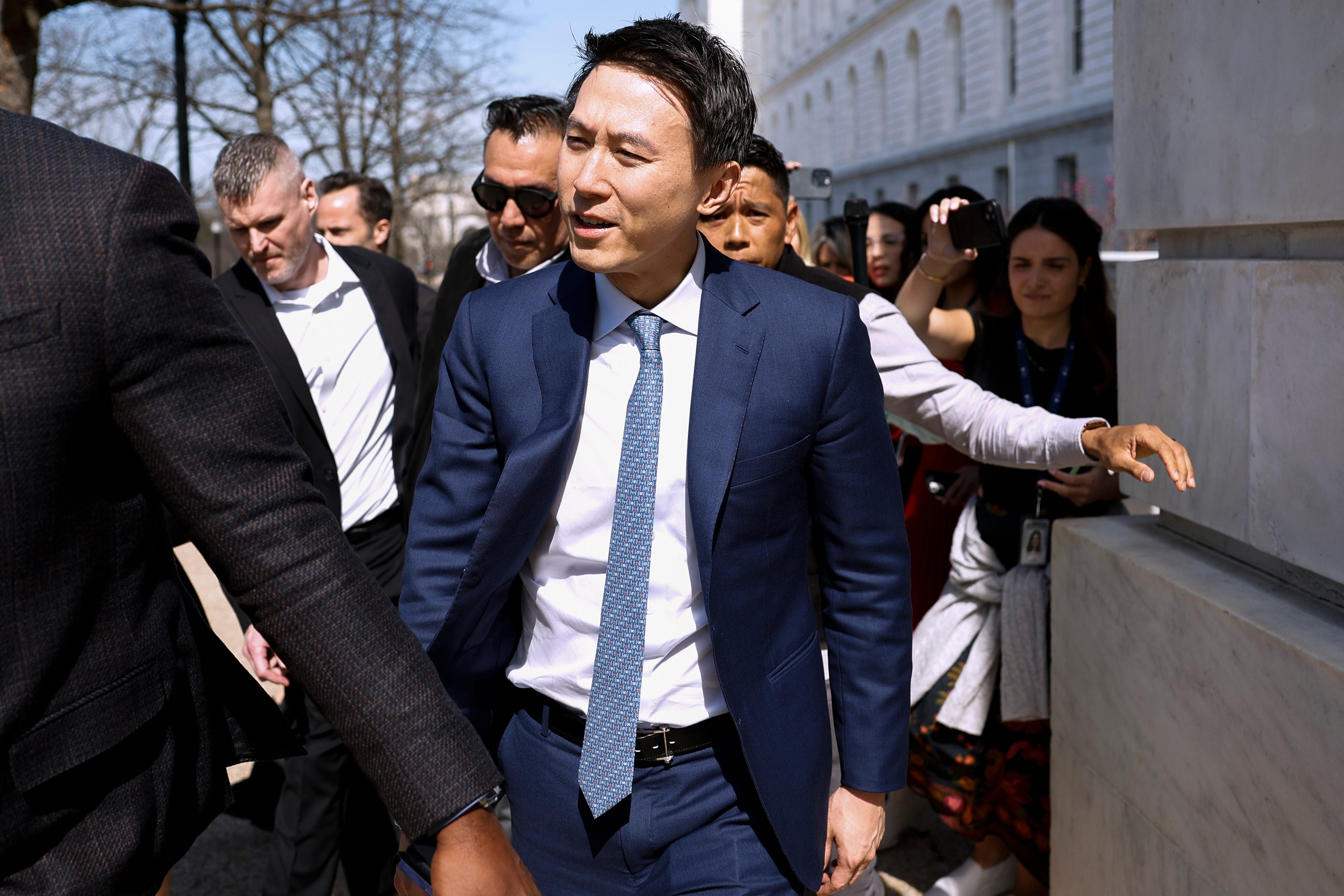 TikTok CEO Shou Chew walks in Washington D.C. wearing a blue suit.