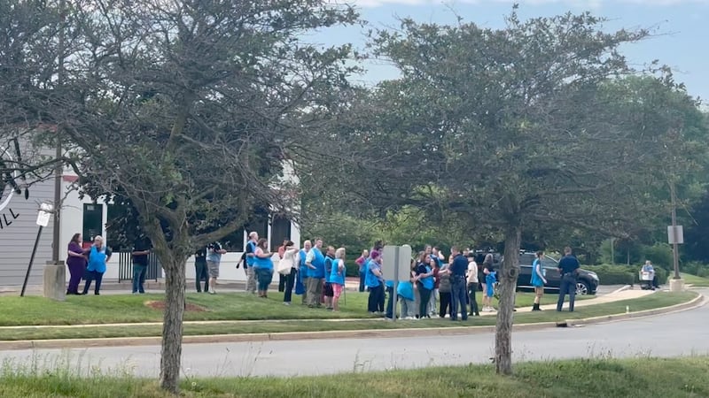 Police officers speak to Walmart employees following a mass stabbing incident in Traverse City, Michigan.