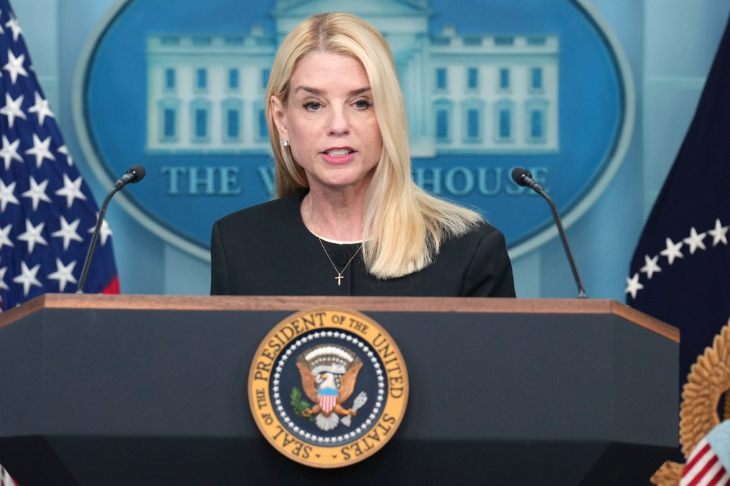 Pam Bondi speaking at a White House podium.