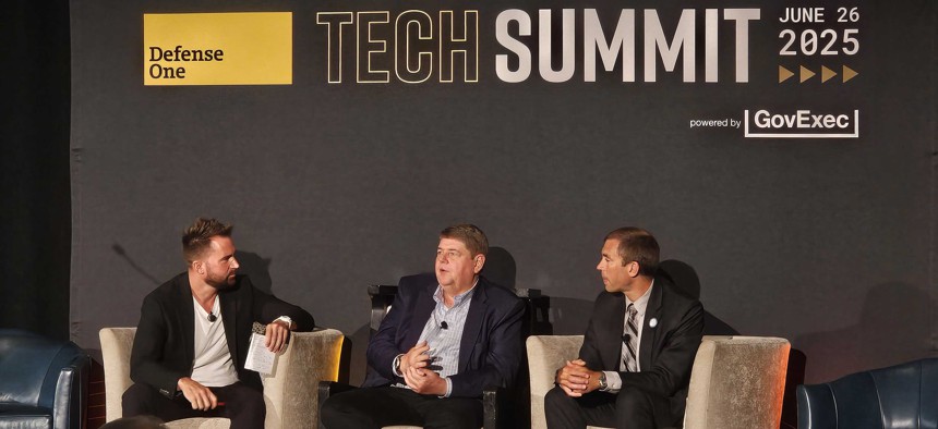 Govexec Editor-in-Chief Frank Konkel (left) interviews Bill Vass, CTO at Booz Allen Hamilton, and Derek Tournear, director of the Space Development Agency, at the Defense One Tech Summit. 