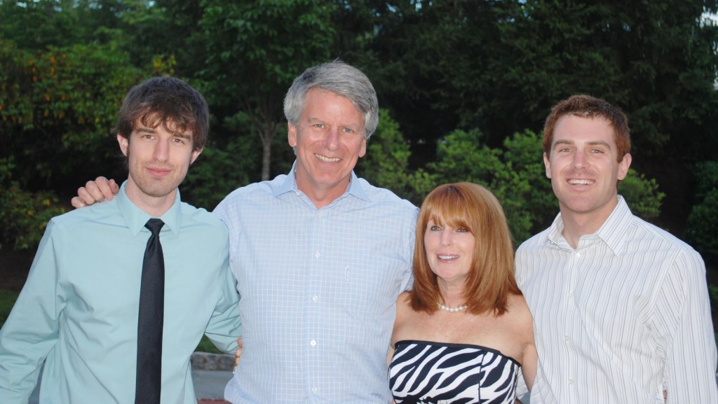 Family portrait of four adults and one child.
