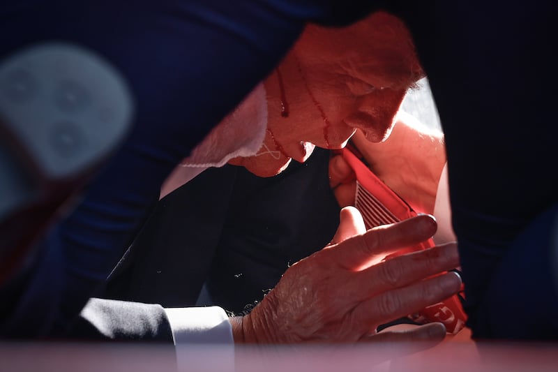 BUTLER, PENNSYLVANIA - JULY 13: Republican presidential candidate former President Donald Trump is shown covered by U.S. Secret Service agents after an incident during a rally on July 13, 2024 in Butler, Pennsylvania. Butler County district attorney Richard Goldinger said the shooter is dead after injuring former U.S. President Donald Trump, killing one audience member and injuring another in the shooting. (Photo by Anna Moneymaker/Getty Images)