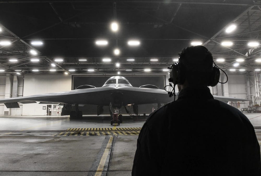 A US Air Force airman poses in front of a B-2 Spirit