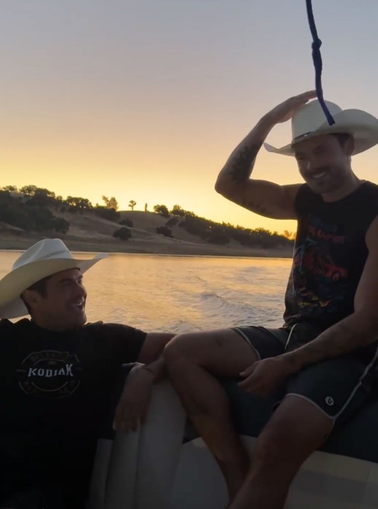 Zac Efron and Dylan Efron pose with hats.