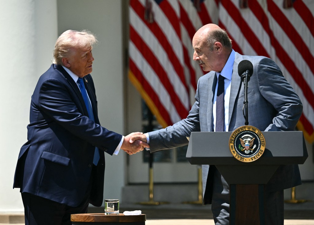 President Trump shaking hands with Dr. Phil at a White House event.