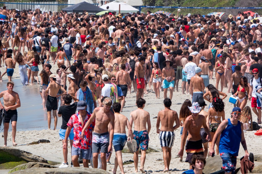 Thousands of young people celebrate the Fourth of July along the coast in La Jolla on a hot summer day on July 4, 2023 in San Diego, California.