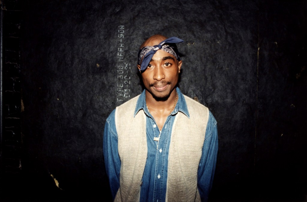 Tupac Shakur posing backstage after a concert.