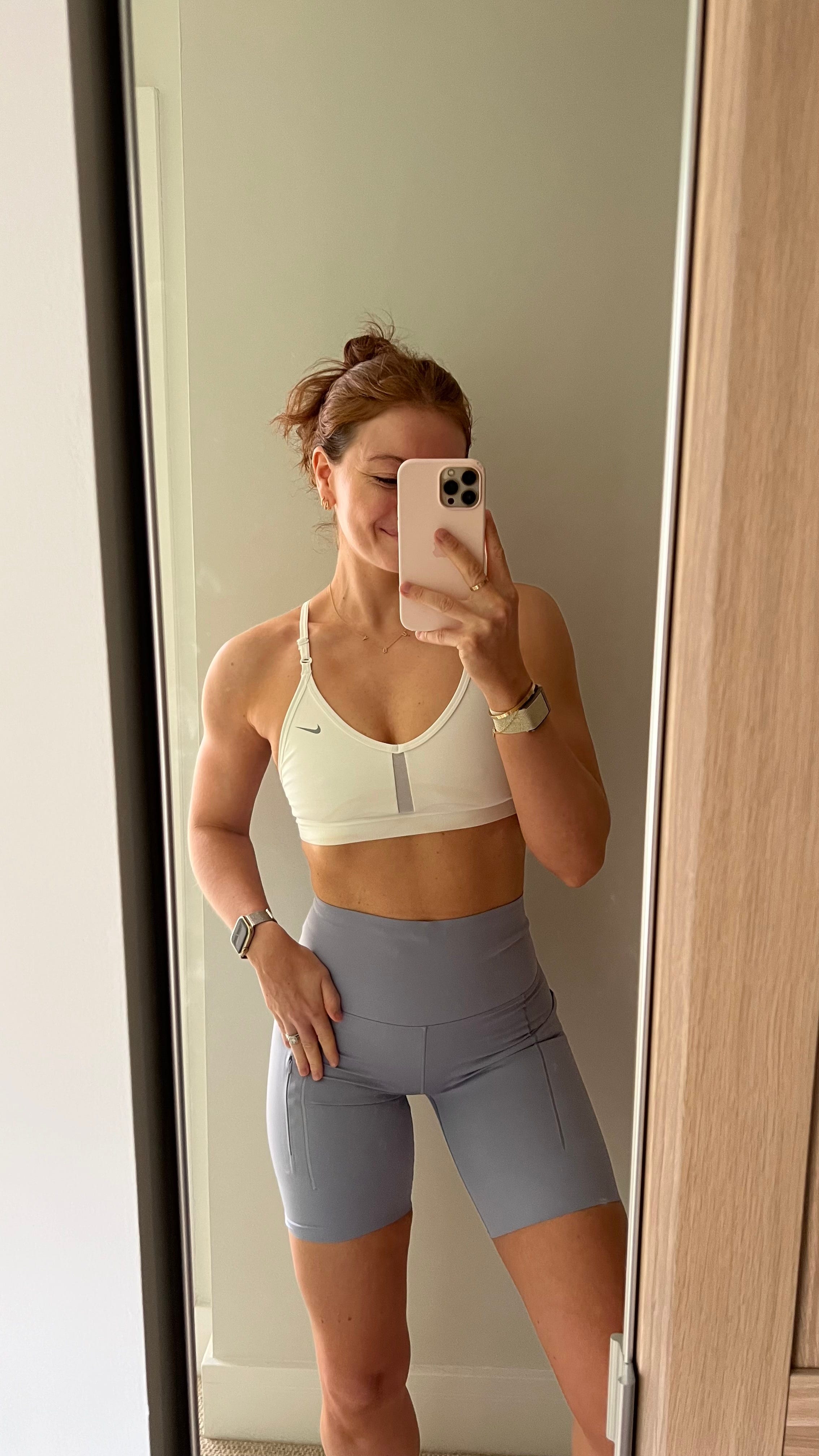 Emily Ricketts taking a mirror selfie in activewear.