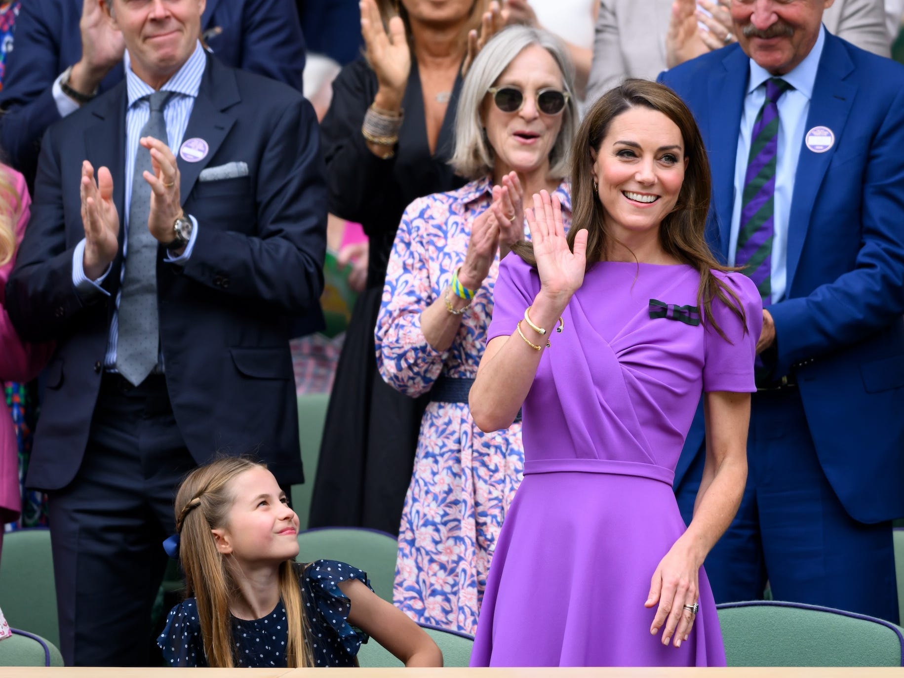 Princess Charlotte and Kate Middleton sit in a crowd at Wimbledon.