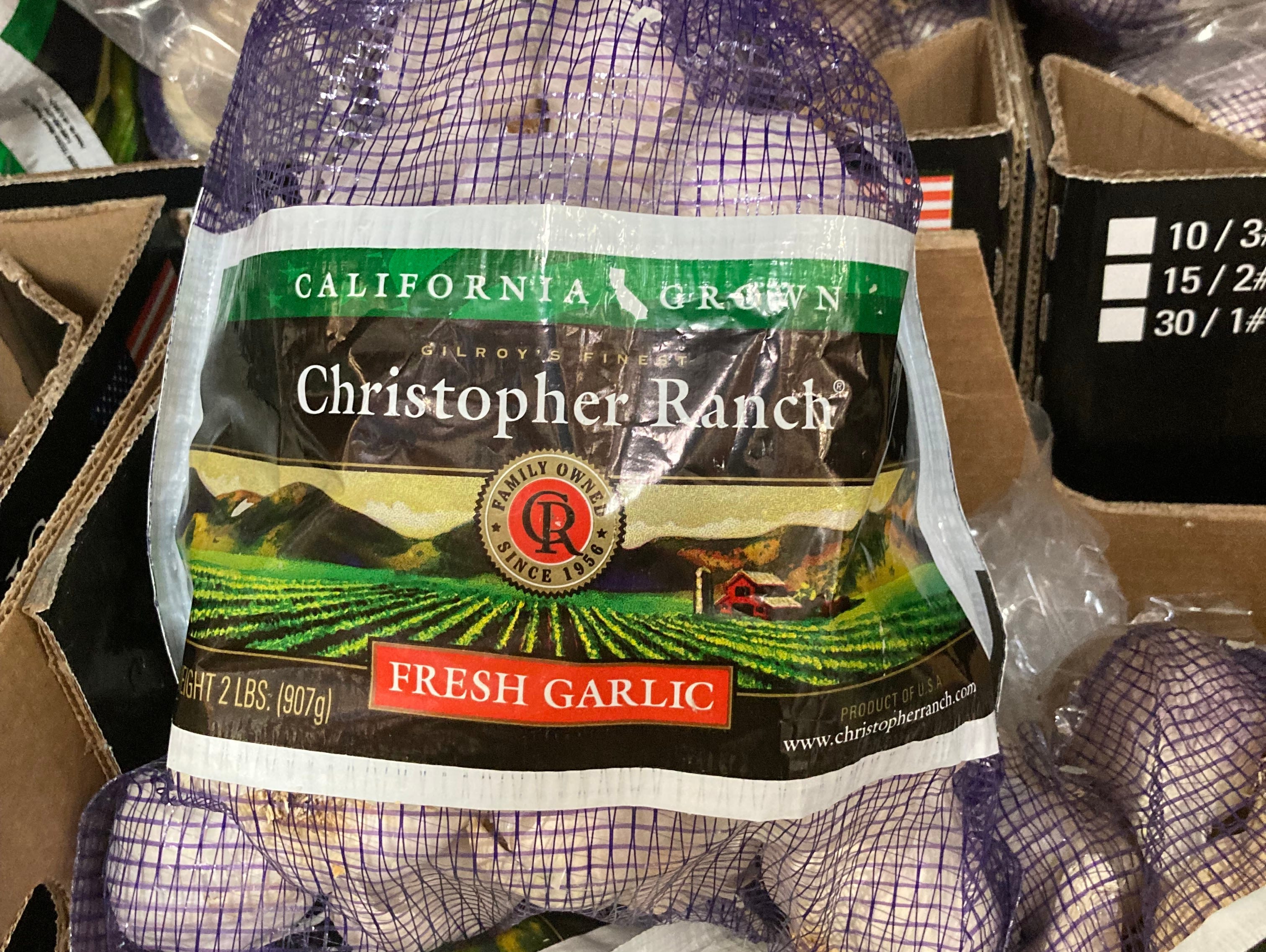 Purple mesh bag of fresh garlic at Costco