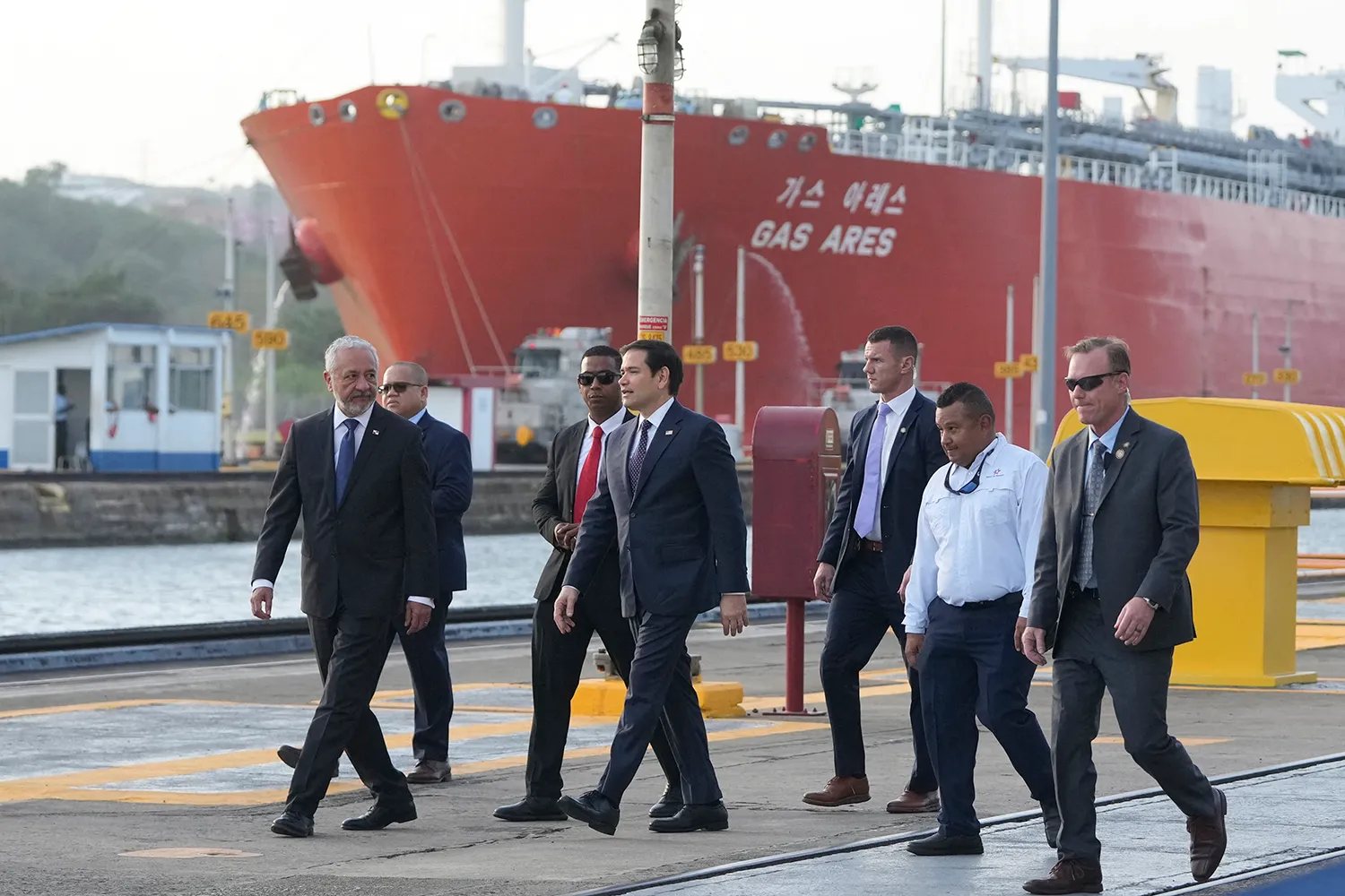 Marco Rubio walks with a group near a ship in the Panama Canal.