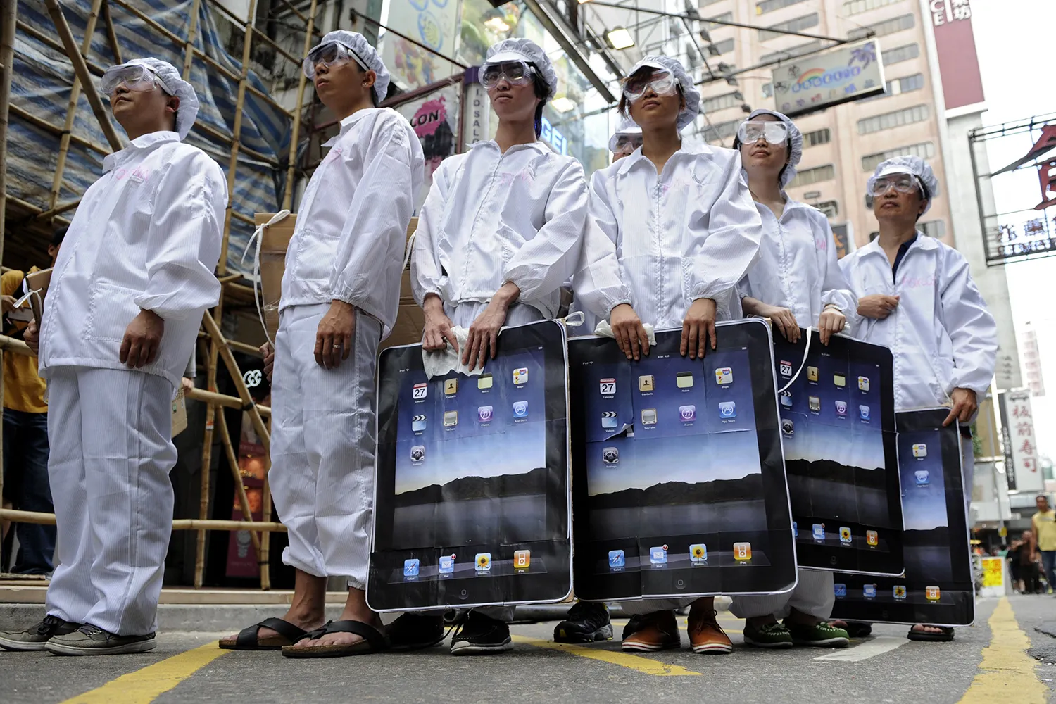 Participants dressed up as workers take part in a protest against Foxconn, which manufactures Apple products in mainland China, outside an Apple retail outlet in Hong Kong on May 7, 2011.