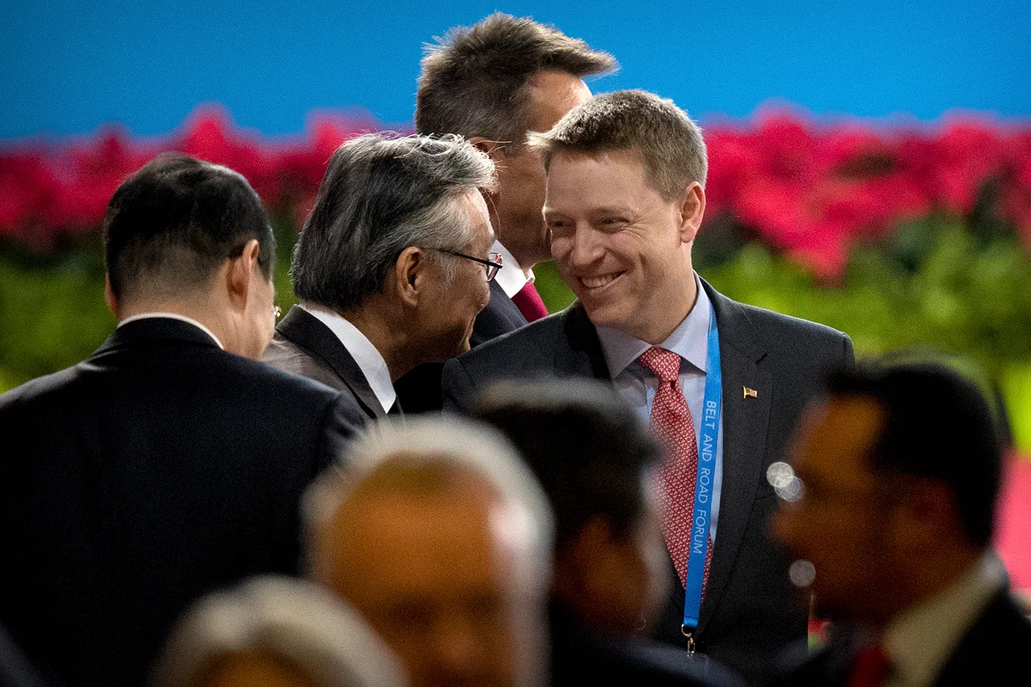 Matt Pottinger smiles in a group of people.