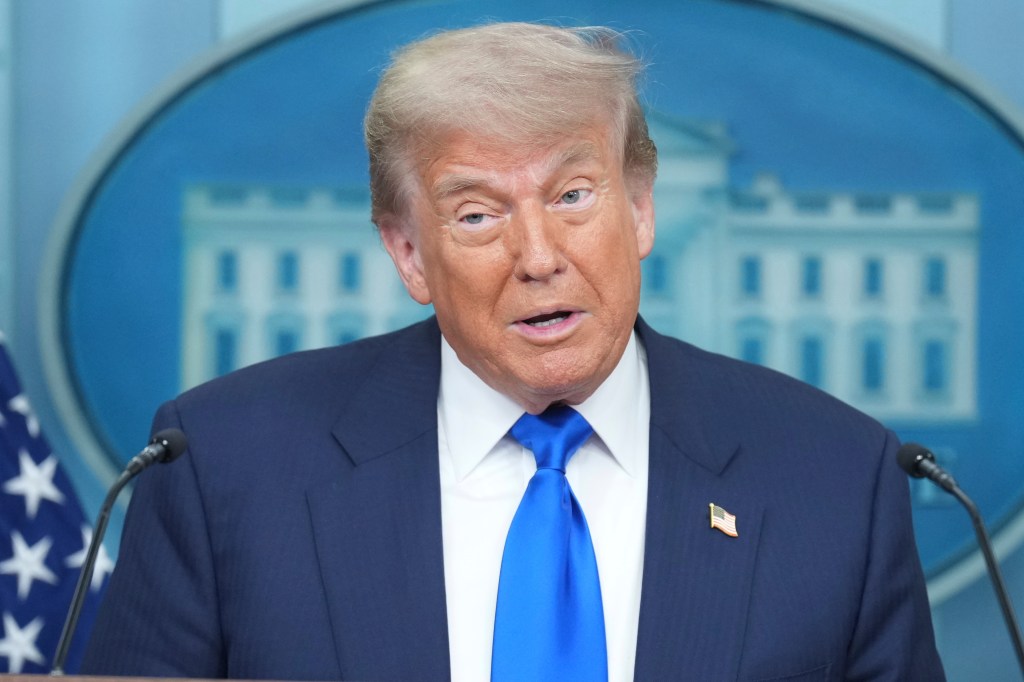 Donald Trump speaking at a podium.