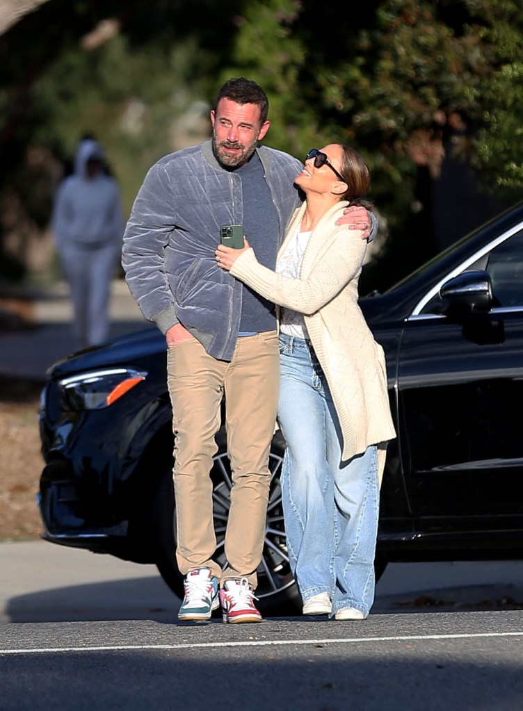Ben Affleck and Jennifer Lopez share a kiss while out for a morning walk