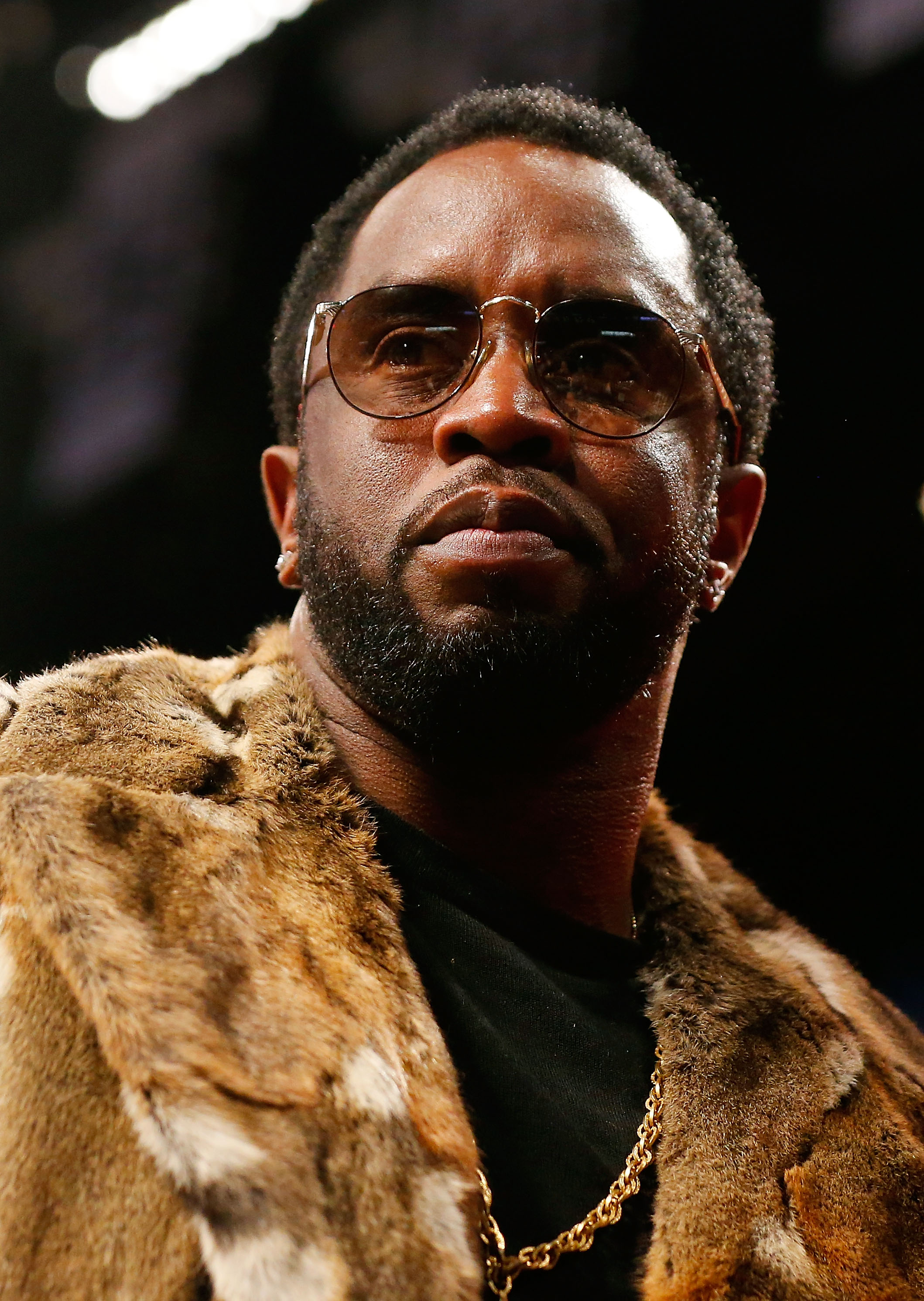 Sean Combs in a gold jacket and sunglasses.