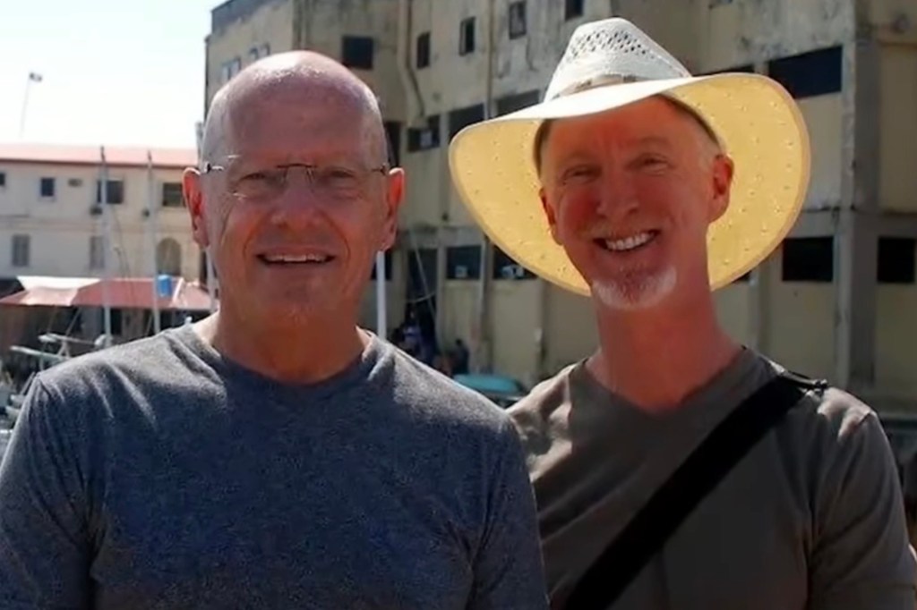 Photo of two men standing outdoors.