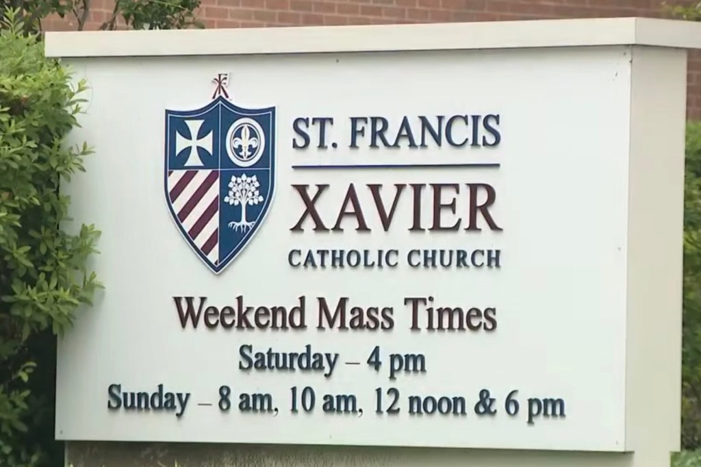 St. Francis Xavier Catholic Church sign with weekend mass times.
