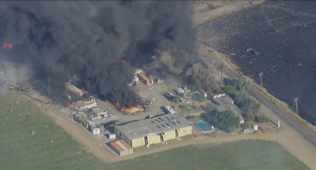 Smoke and flames rise at a fireworks warehouse near Esparto, Calif., on Tuesday, July 1, 2025. 