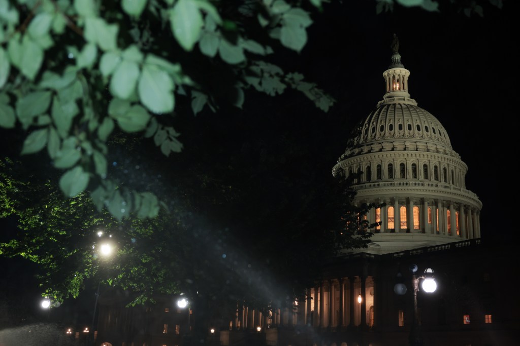 Nighttime view of the US Capitol building.