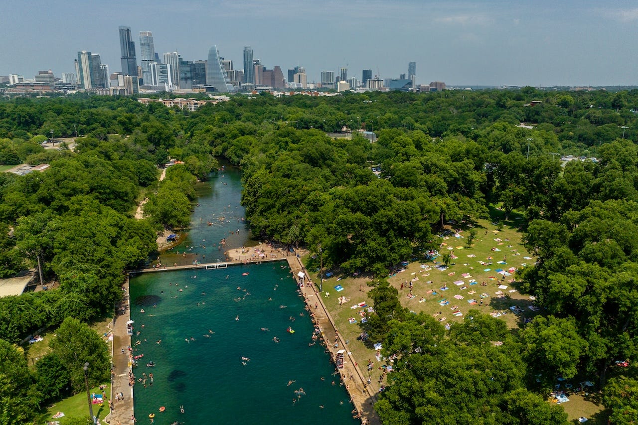 An aerial view of Barton Springs Pool and downtown Austin, Texas.