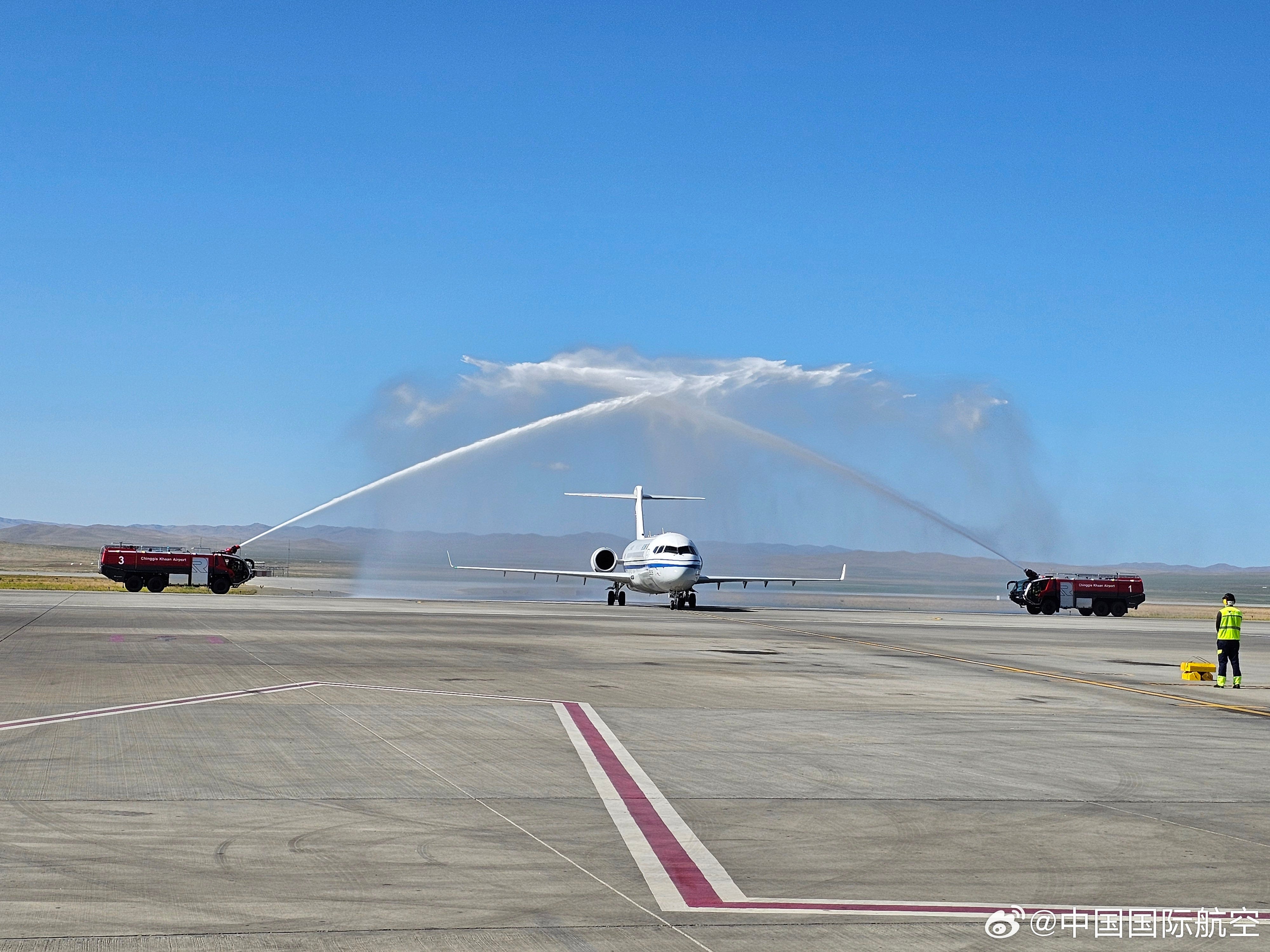 An Air China C909 is greeted by a water-cannon salute at Ulaanbaatar Airport on July 1, 2025.