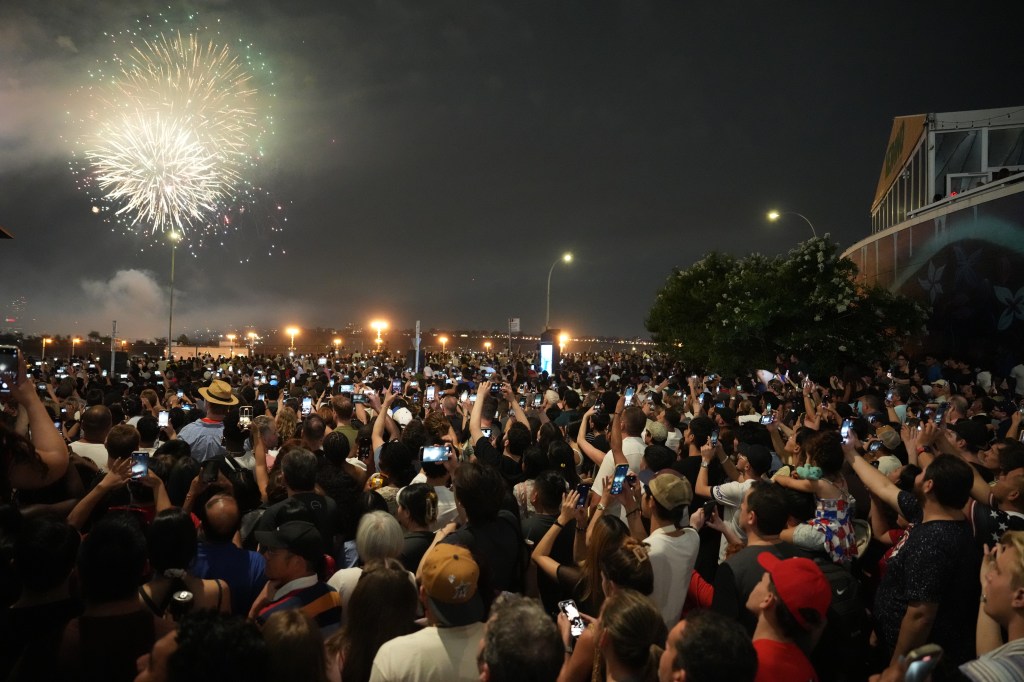 Spectators gather to watch the Macy's 4th of July fireworks show over the Hudson River on Thursday, July 4, 2024 in New York.