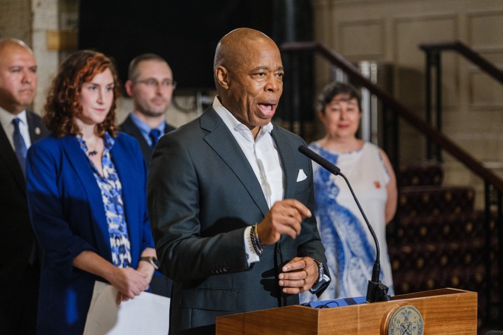 Mayor Eric Adams speaking at a podium.