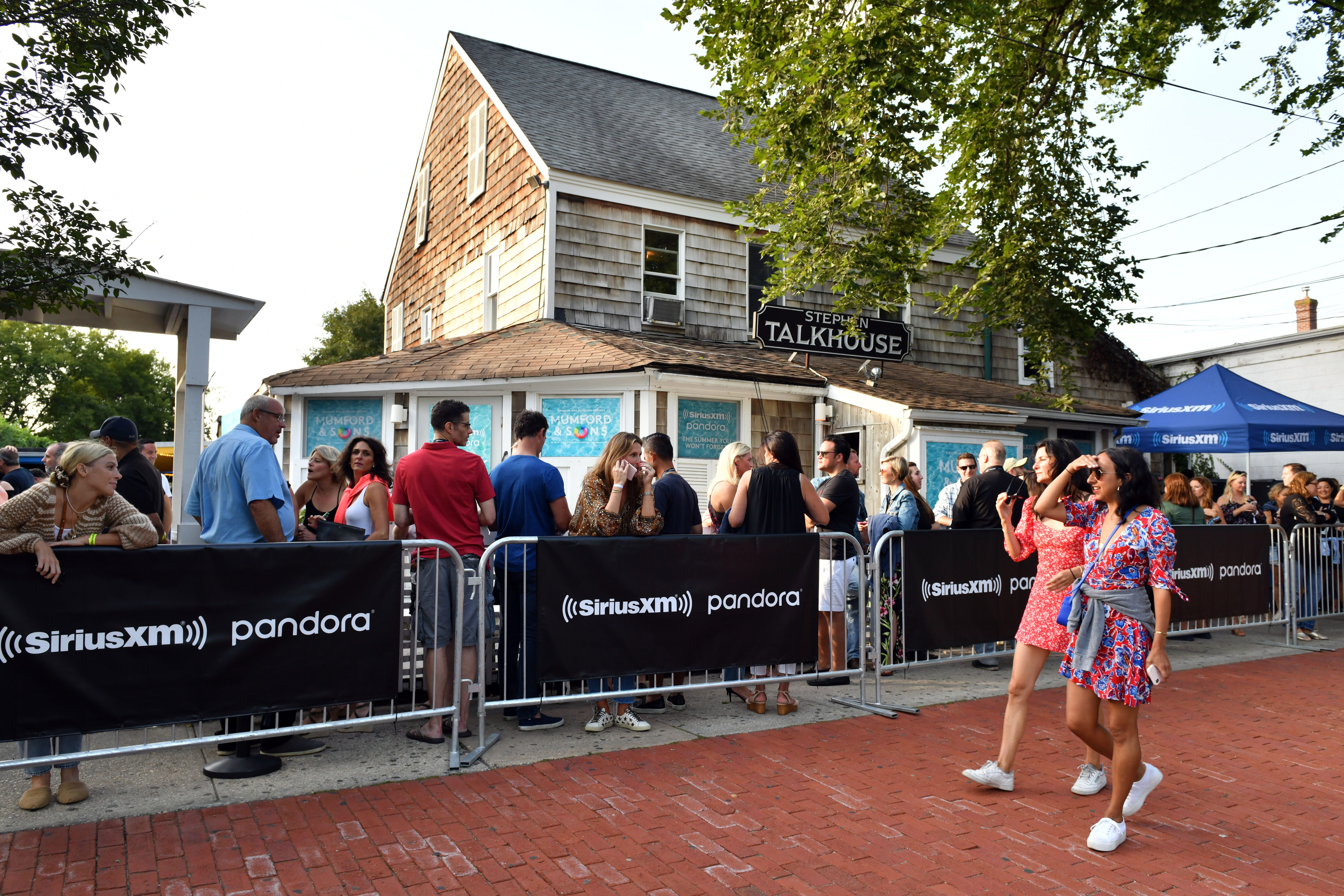 People mill about in front of a restaurant