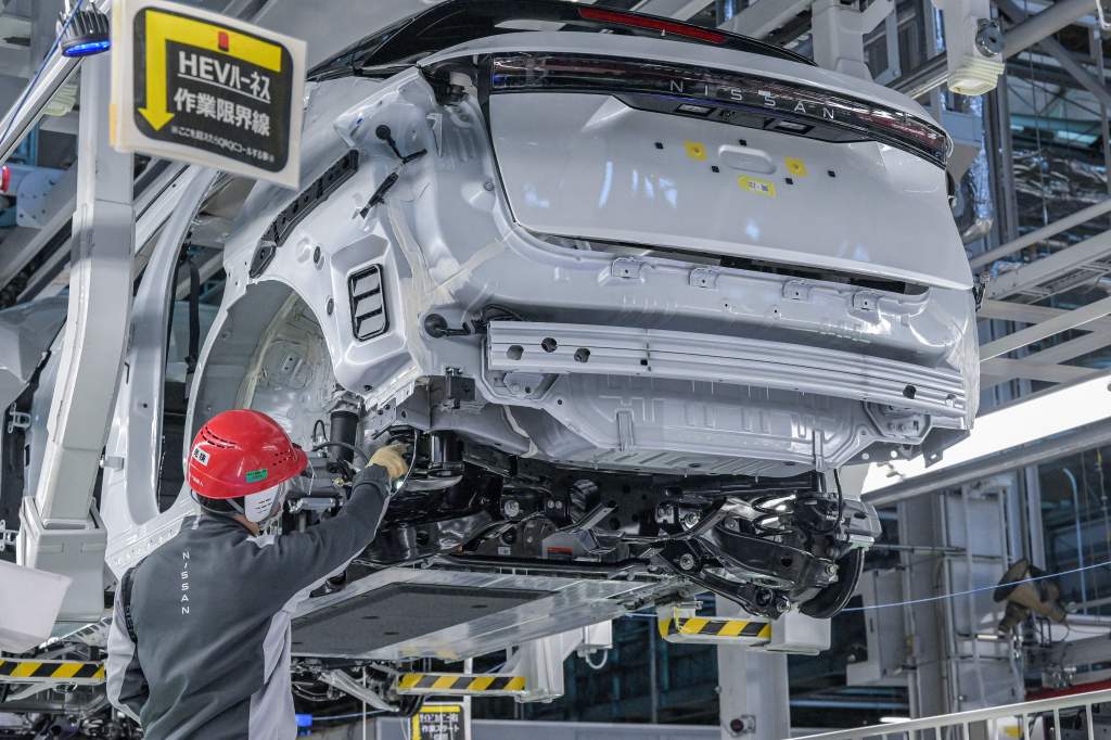 A Nissan car in a factory undergoing assembly.