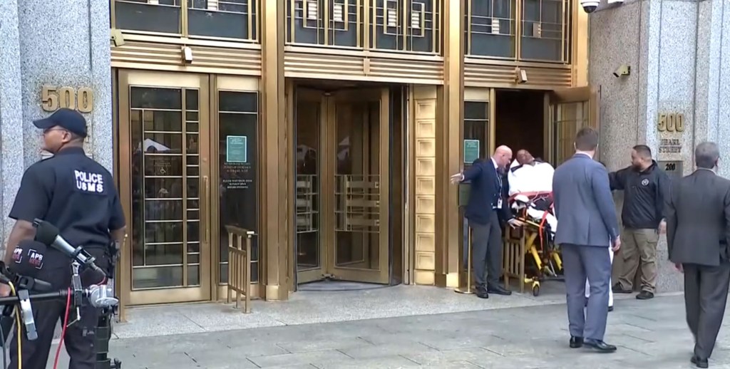 A man being removed on a stretcher.