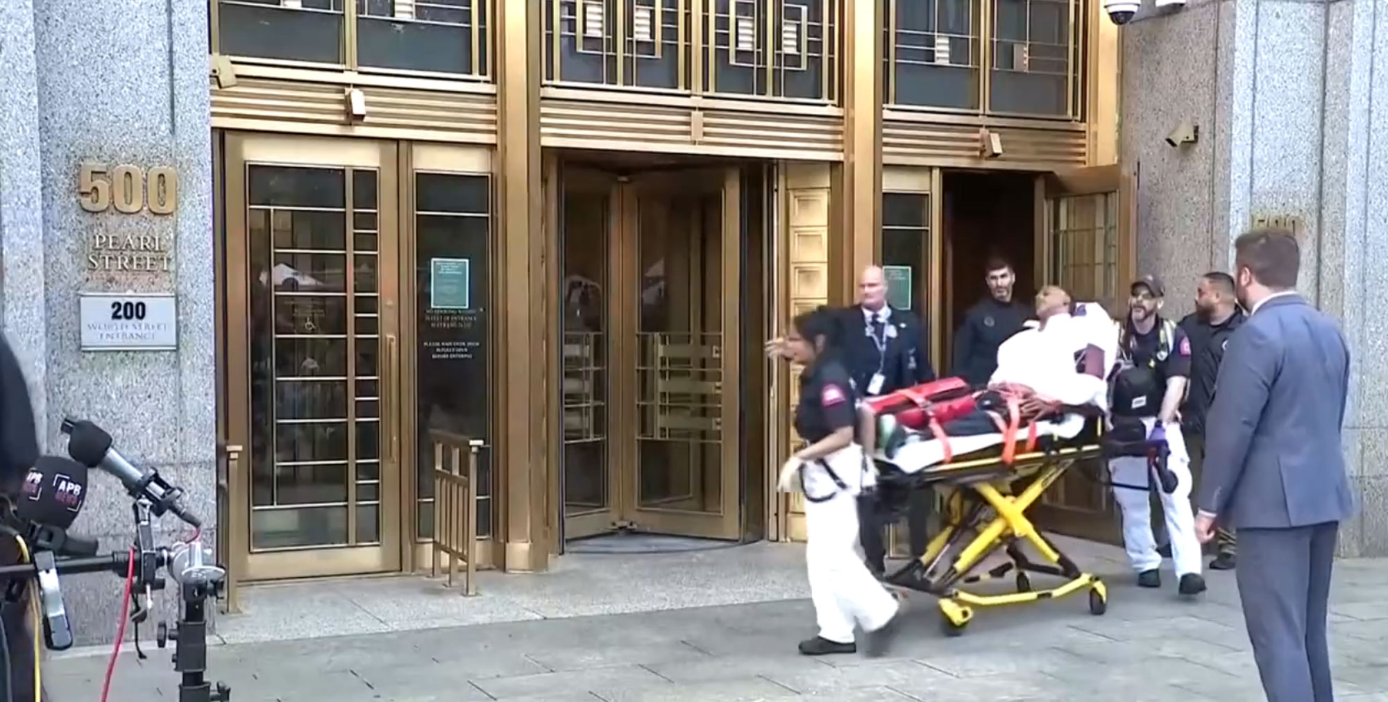 A man being removed on a stretcher.
